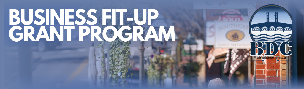 Downtown Bath street scene with local shop signs and brick buildings, overlaid with text reading “Business Fit-Up Grant Program” and the Bath Development Corporation (BDC) logo featuring the Sagadahoc Bridge.